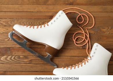 Pair Of Skates With Untied Laces On Wooden Background