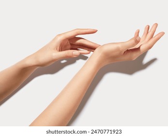 A pair of slender hands on a white background - Powered by Shutterstock