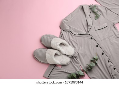 Pair of slippers, pajamas and eucalyptus branches on pink background, flat lay. Comfortable home outfit - Powered by Shutterstock