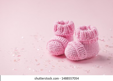 Pair of small baby socks on pink background with copy space for your warm message, baby shower, first newborn party background, copy space, cute minimal postcard