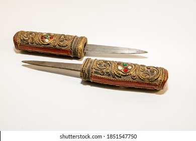Pair of small Burmese knives whose short and sharp blades disappear inside what are simultaneously scabbards and handles.