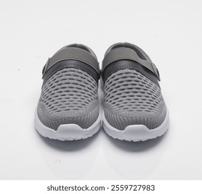 a pair of sneakers with a gray band on the bottom. - Powered by Shutterstock