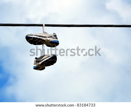 A Pair Of Sneakers Hanging From A Power Line