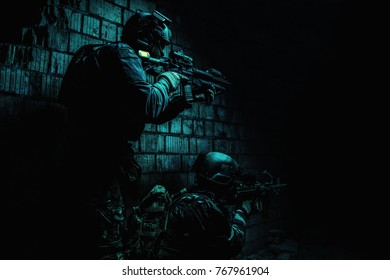 Pair of soldiers in action under cover of darkness low angle - Powered by Shutterstock