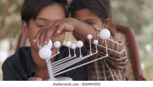 A Pair Of South Asian Children Playing With Educational Toys