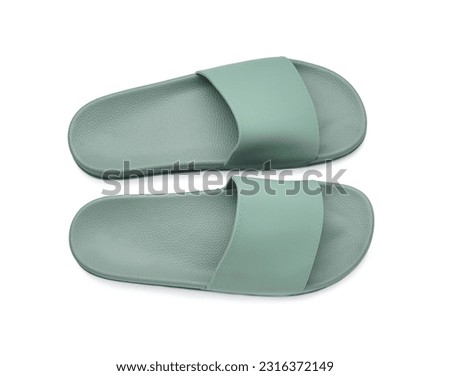 Pair of stylish green flip-flops on white background