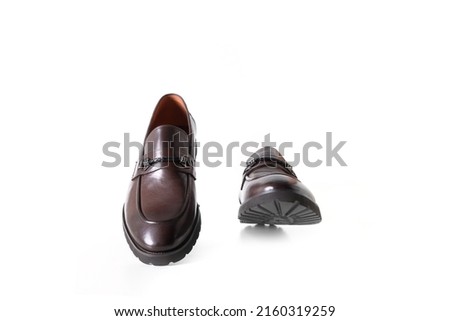 Pair of stylish modern male brown loafers shoes isolated on white background. Fashion concept with mans shoes on white.