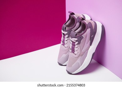 A pair of stylish women's sneakers. Violet and pink color, paper background - Powered by Shutterstock