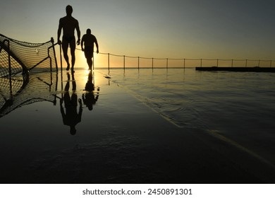 Pair of swimmers preparing for an early morning dip at Bronte Outdoor swimming baths, Sydney, Australia. - Powered by Shutterstock