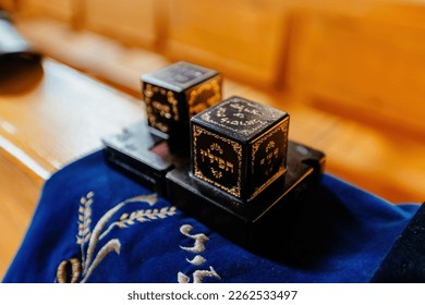 A pair of tefillin on a synagogue bench. Translation from Hebrew to English : ישראל =Israel, תפילין=tefillin