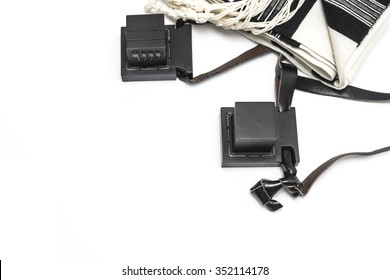 pair of tefillin and Tallit A symbol of the Jewish people, a pair of tefillin with black straps, isolated on a white background, with room for text. (Bar Mitzvah Jews 13 years old) 