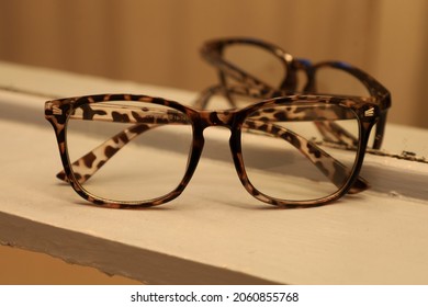 A Pair Of Tortoise Shell Glasses Reflected In A Mirror In A Little Rural Shop.