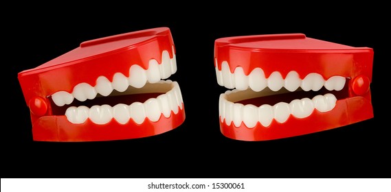 A pair of toy chattering teeth isolated on a black background with a clipping path