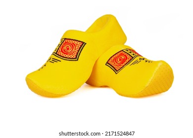 Pair of traditional Dutch yellow wooden shoes over white background. Popular souvenirs. Traditions of Holland