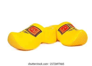Pair of traditional Dutch yellow wooden shoes over white background. Popular souvenirs. Traditions of Holland