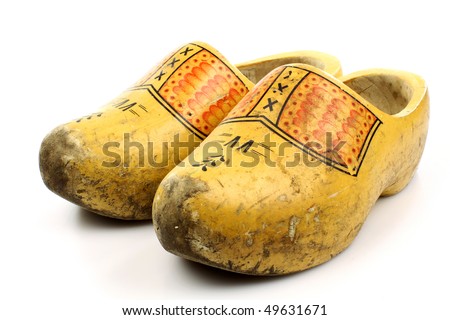 pair of traditional Dutch yellow wooden shoes isolated on a white background