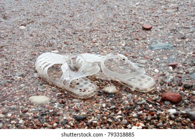 Pair Of Transparent Retro Jelly Sandals On Sandy Beach