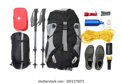 Pair of trekking poles and camping equipment for tourism on white background, top view