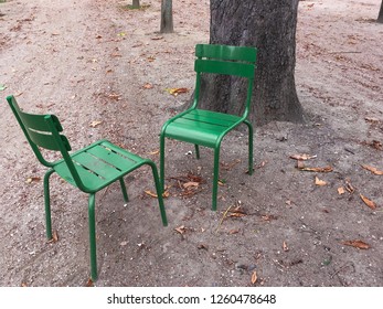 Pair Of Two Empty Garden Chairs Facing Each Other In Paris Park. Concept Of Dialogue, Communication, Discussion Confrontation, Opposition Or Meeting Place. Isolated Metal Seat Furniture, No People. 