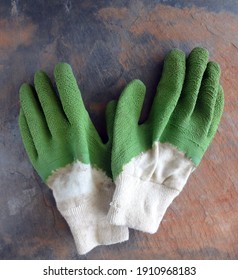 A Pair of Used Garden (Work) Gloves on a Rustic Slate Background