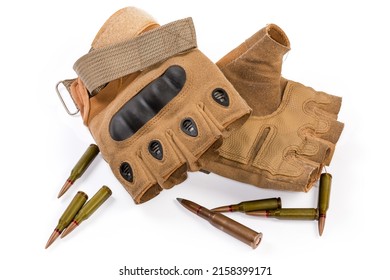 Pair of the used leathern tactical military fingerless gloves with hard knuckle protection among the diferent rifle cartridges on a white background