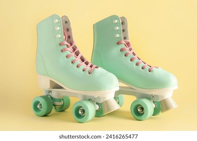 Pair of vintage roller skates on beige background