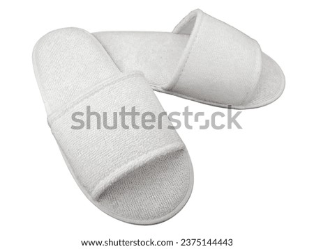 A pair of White comfortable home or spa slippers isolated on white background with clipping path. 
Soft white slip on sandals. Blank pair of hotel slippers, no label, mock up template logo design.