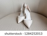 Pair of white shoes commonly called D