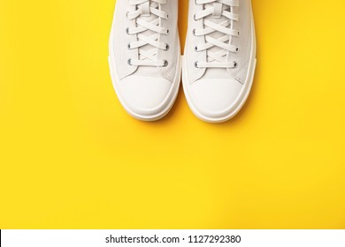 Pair Of White Sneakers On Color Background, Top View