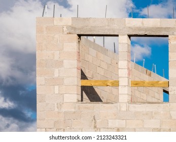 Pair Of Window Openings In Exterior Wall Of Concrete Blocks By Corner Of Single-family House Under Construction On A Sunny Day In Southwest Florida