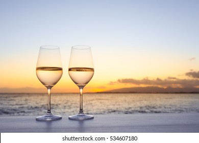 Pair of wine glasses on the beach. - Powered by Shutterstock