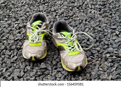 A Pair Of Worn Out Running Shoes