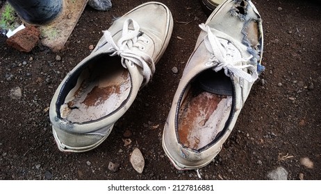 A Pair Of Worn And Torn Shoes