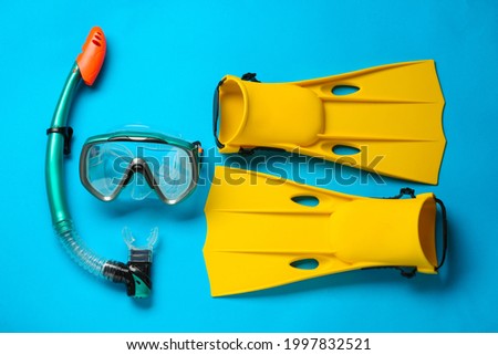 Pair of yellow flippers and mask on light blue background, flat lay ストックフォト © 