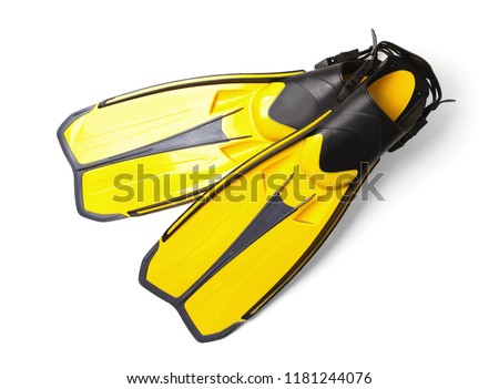 Pair of yellow flippers on white background, top view