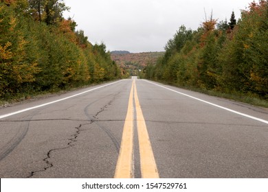 Pair of yellow lines on gray asphalt road. Canada
