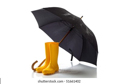 A Pair Of Yellow Rain Boots And A Black Umbrella On A White Background