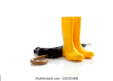 A Pair Of Yellow Rainboots And A Black Umbrella On A White Background 