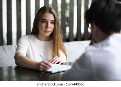 A pair of young people talking at the office table - Shutterstock ID 1379443565