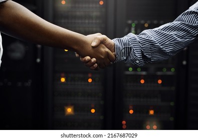 Paired up for professional IT service. Cropped shot of two unrecognizable men shaking hands in front of a server in a data center. - Powered by Shutterstock