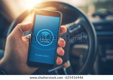 Pairing Smartphone with Car Multimedia Audio System. Using Mobile Phone Device While Driving. Hands Free Talking and Listening Online Music While Traveling by Car.