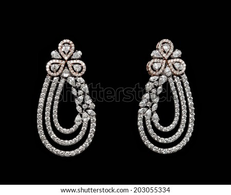 Pairs of Earrings with diamonds isolated over black background
