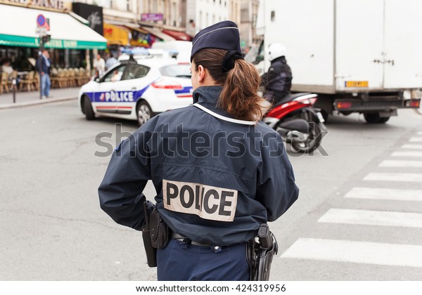 Pairs,\
France - May 15, 2013.:Uniformed Paris Police officers patrolling\
traffic near the River Seine in Paris,\
France
