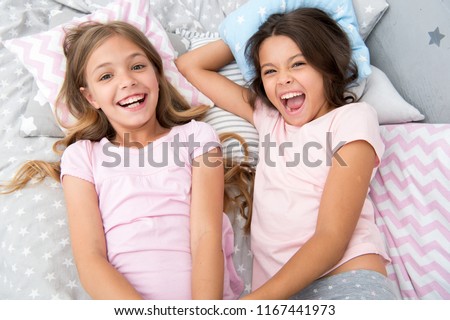 pajama party and friendship. pajama party of two happy small kids in bedroom. friendship of small kids girls with happy faces. yeah.