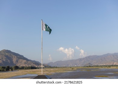 Pakistan flag with a beautiful mountains and river landscape background