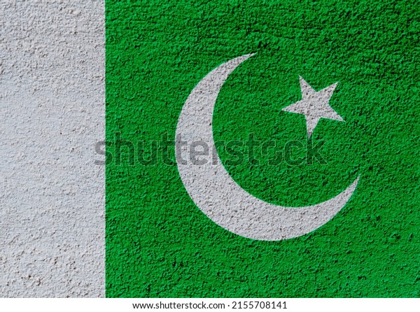 Pakistan flag on concrete\
wall.