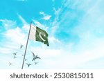 Pakistan flag waving with flying doves in beautiful sky. Pakistan flag for Republic Day and Independence Day.