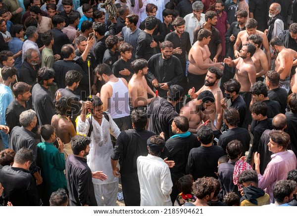 Pakistan , Multan - August 19, 2021: Ashura
islamic holy day for shia muslims; mourning azadari rituals.
Remembrance ceremonies for martyrdom of Imam Hussain. Ritual
self-flagellation with
chains