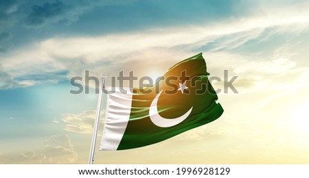 Pakistan national flag waving in beautiful clouds.
