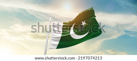 Pakistan national flag waving in beautiful clouds.
